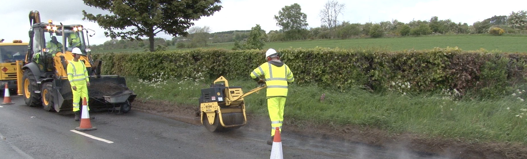 workers resurfacing country road